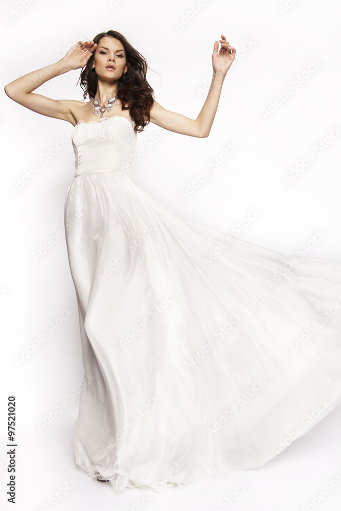 Brunette in white dress posing
Brunette in white dress posing