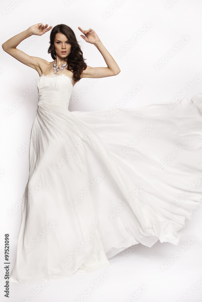 Brunette in white dress posing
Brunette in white dress posing