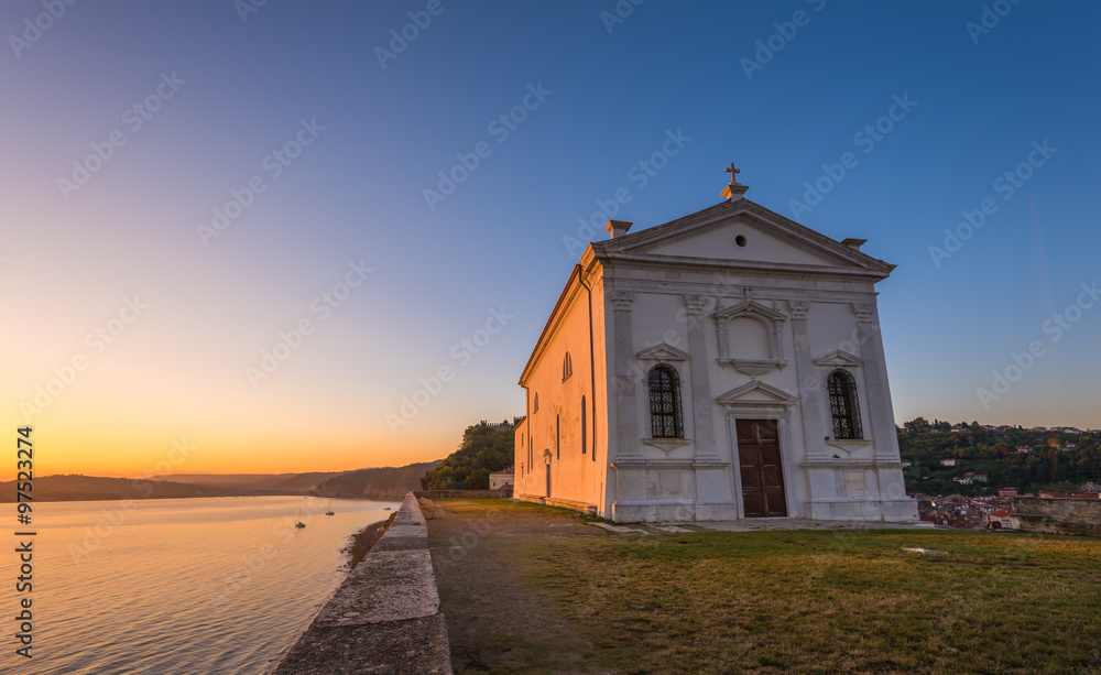 St. George's Church in Piran, Slovenia at Sunrise with Clear Blue Sky