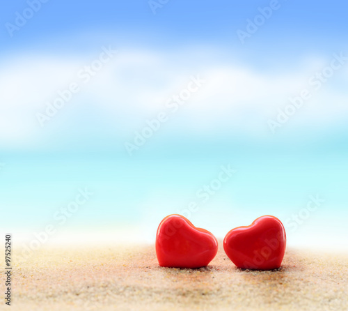 Two hearts on the summer beach. Valentines Day.