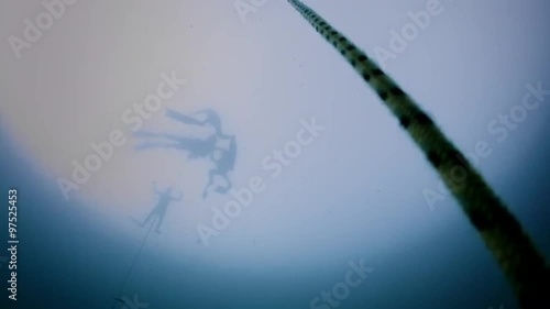 Underwater video of a Freediver in silhouette going down in Free Immersion using a Rope (Transition to black).
