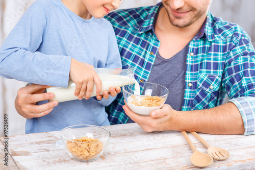 Positive father and daughter having breakfast 