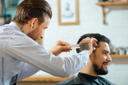 Professional barber making haircut 
