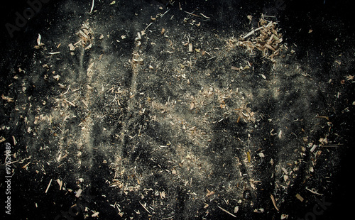 Explosion of sawdust on black background. photo