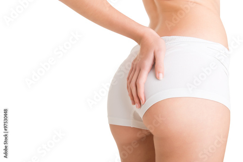 Woman Examining Her Buttocks for Cellulite photo
