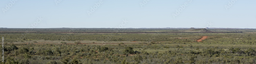 Mile long iron ore train in the Hamersley ranges western australia. Mile long iron ore train in the Hamersley ranges western australia.