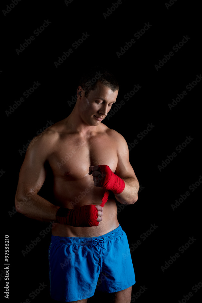 Athlete takes off hand bandages after training Athlete takes off hand bandages after training