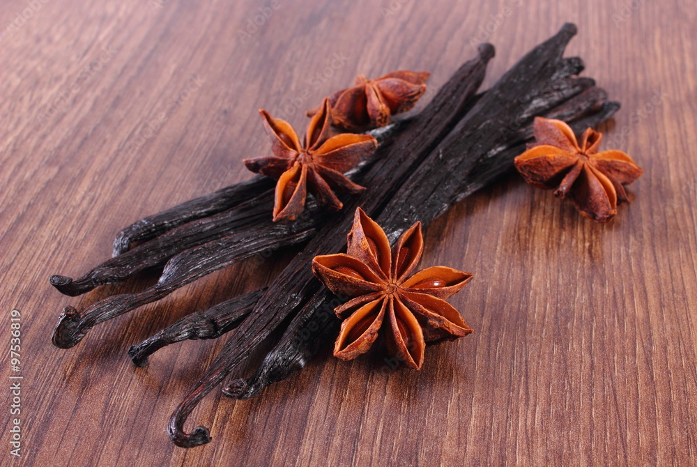 Fragrant vanilla and star anise on wooden surface plank Fragrant vanilla and star anise on wooden surface plank