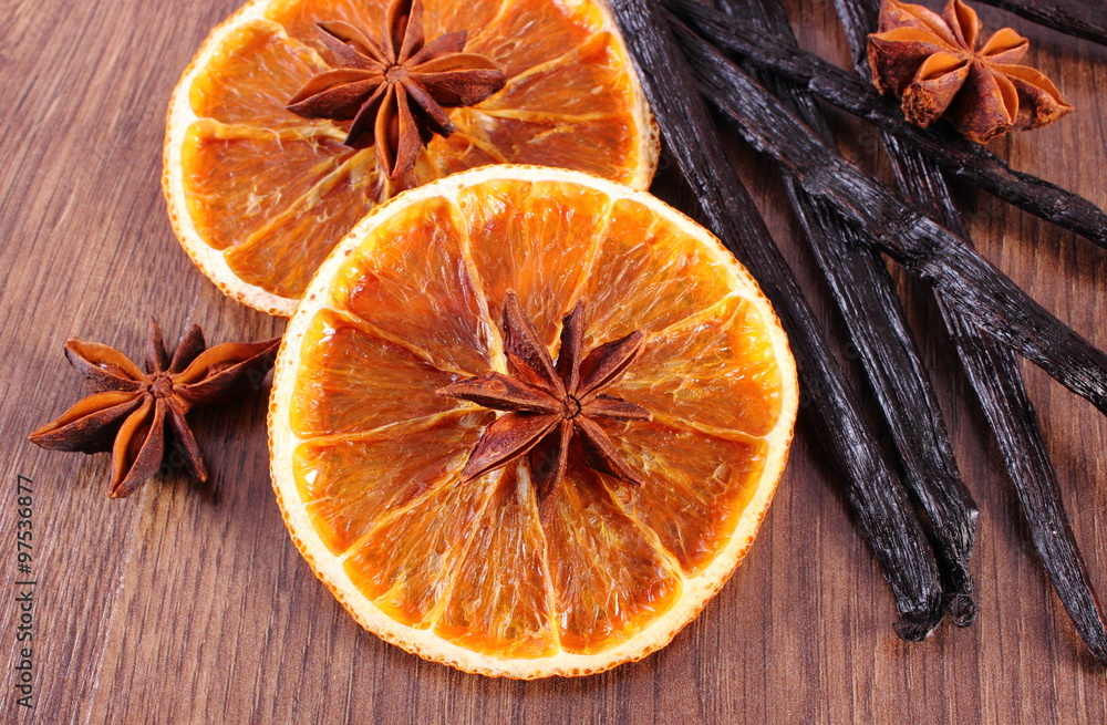 Fragrant vanilla, star anise and dried orange on wooden surface plank Fragrant vanilla, star anise and dried orange on wooden surface plank