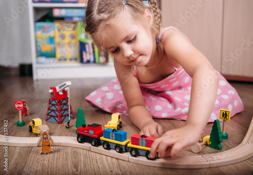 Girl play with a toy train