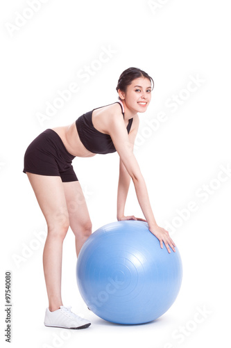 Young woman doing exercises with fitness ball 