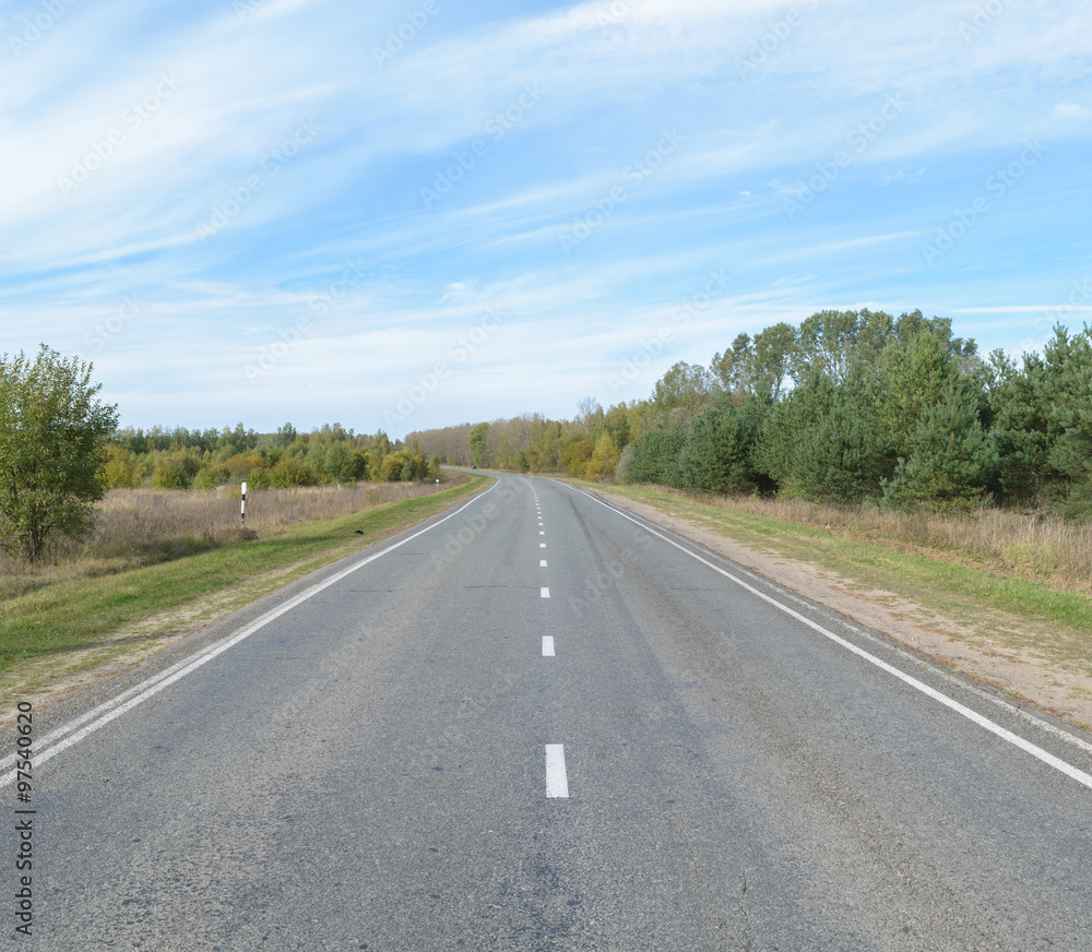 Suburban asphalt highway with white intermittent markings Suburban asphalt highway with white intermittent markings