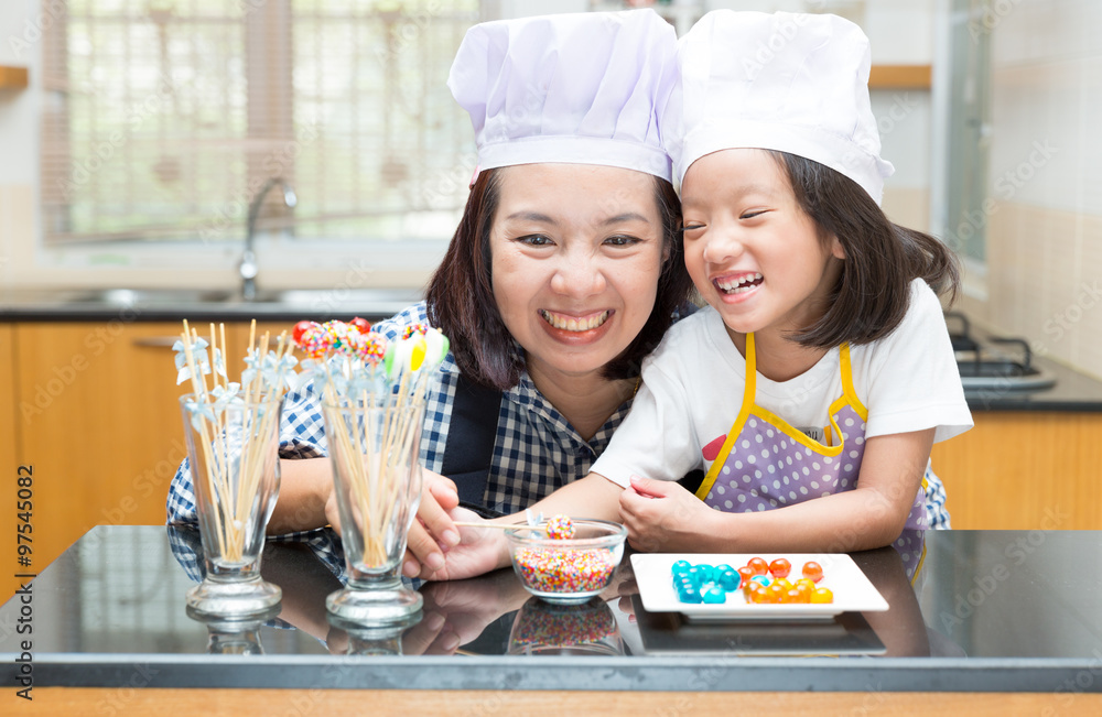 Mother and daughter making jelly ball Mother and daughter making jelly ball