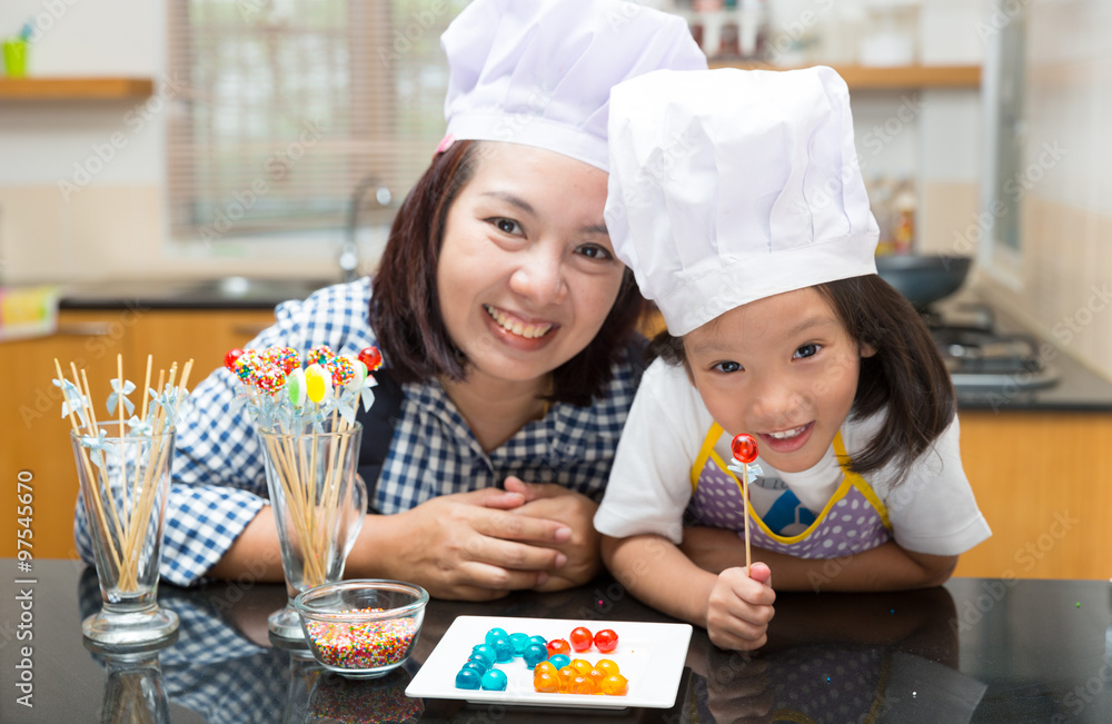 Mother and daughter making jelly ball Mother and daughter making jelly ball