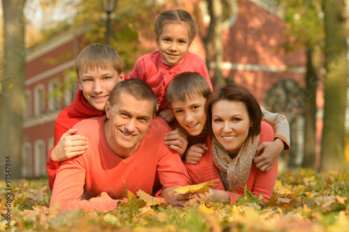 Family relaxing in autumn park