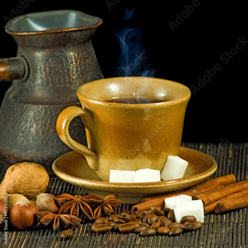 image of a cup of coffee and spices on a black background