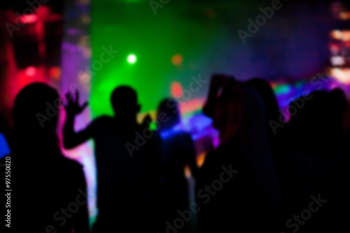 Silhouettes of people dancing in nightclub at a party