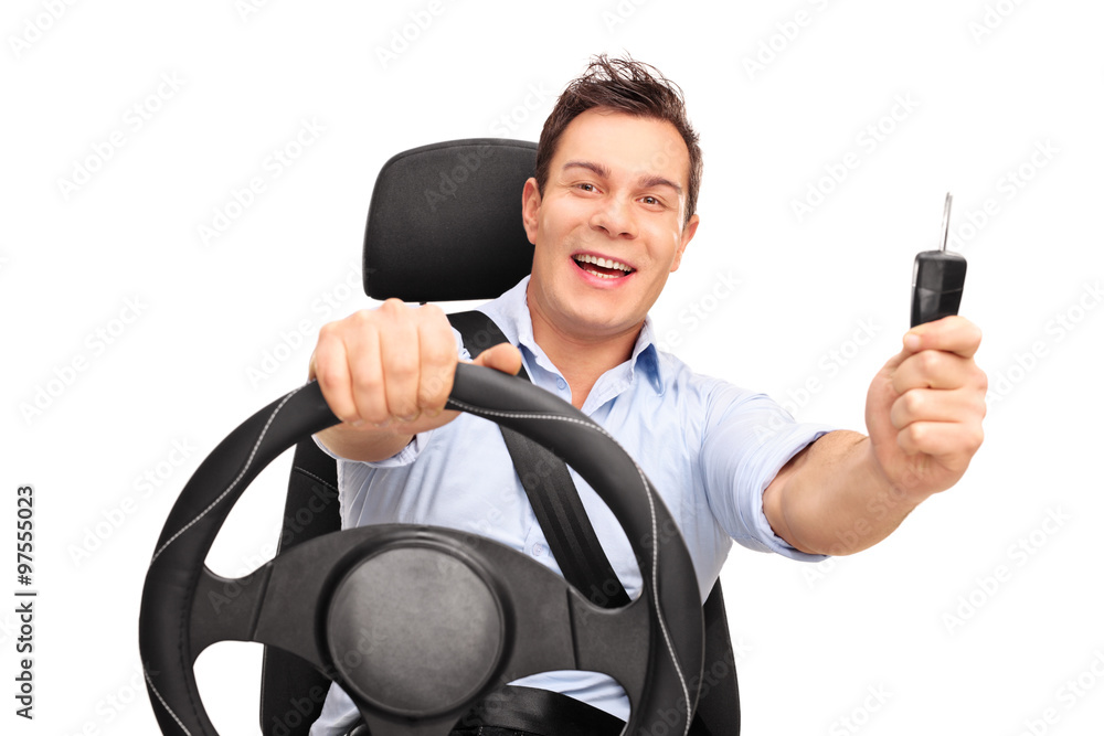 Naklejka premium Young man holding a car key