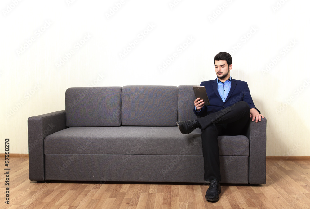 Man with tablet PC sitting on the sofa Man with tablet PC sitting on the sofa
