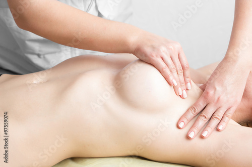 Fototapeta Beauty young woman recieving breast massage at spa