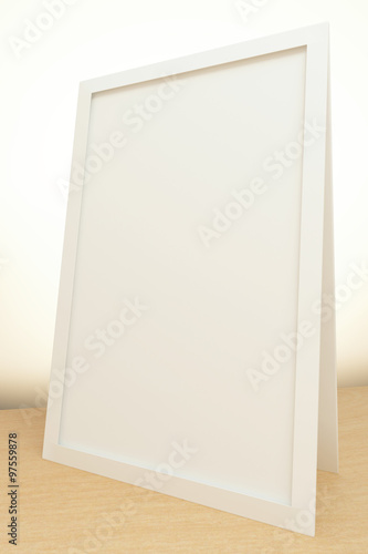 Blank picture frame on the table at white background, mock up