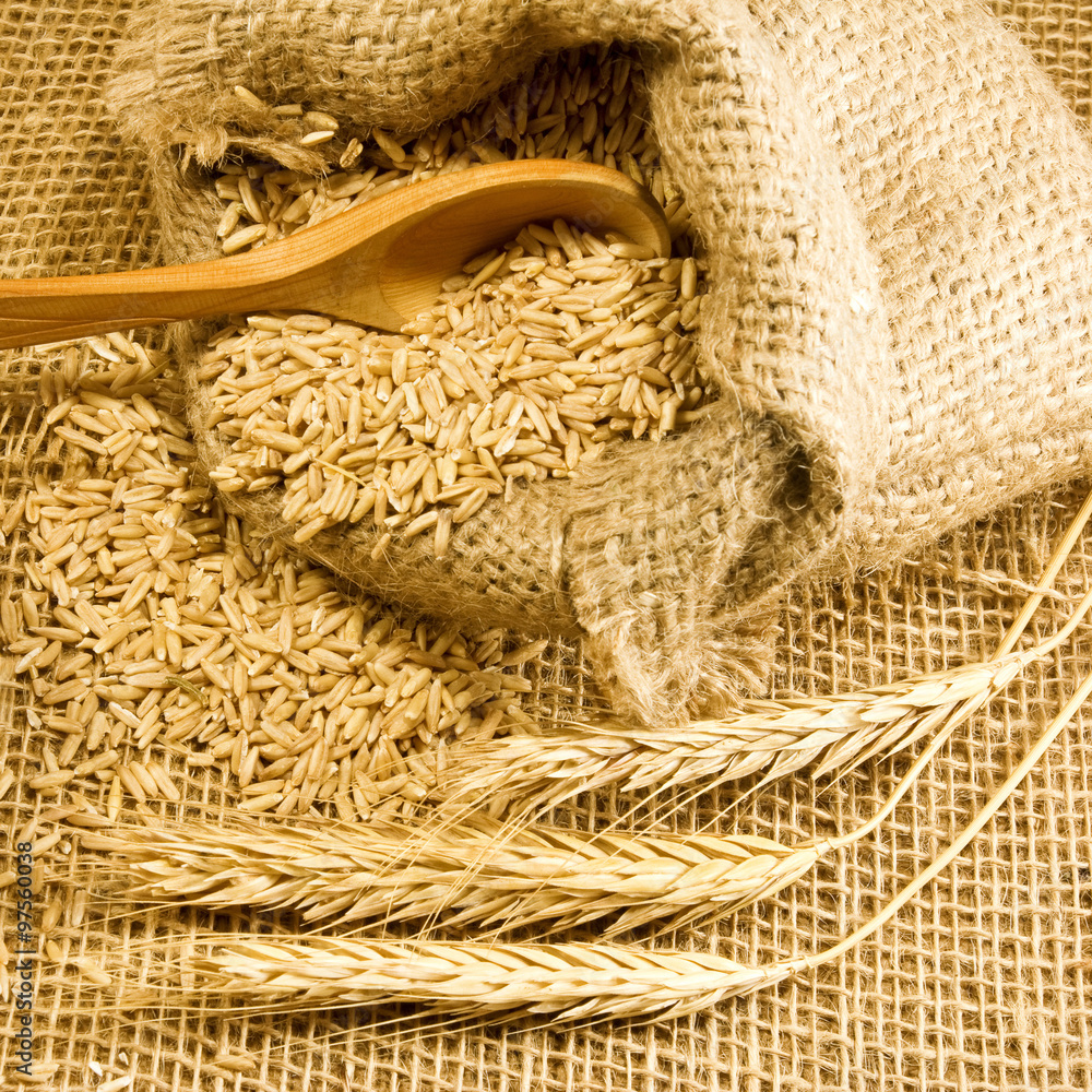 wheat in sack and spikelets on the table