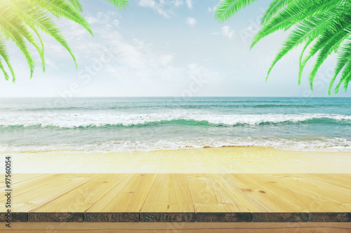 Fototapeta Naklejka Na Ścianę i Meble -  Empty wooden table on the beach with palm trees