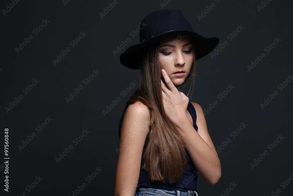 Beautiful woman in hat. Dark Background. Beautiful woman in hat. Dark Background.