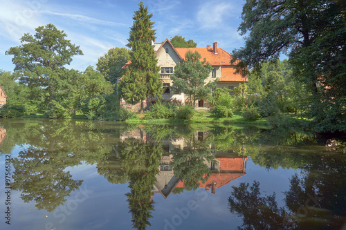 Country landscape with a pond and the palace in Poland.