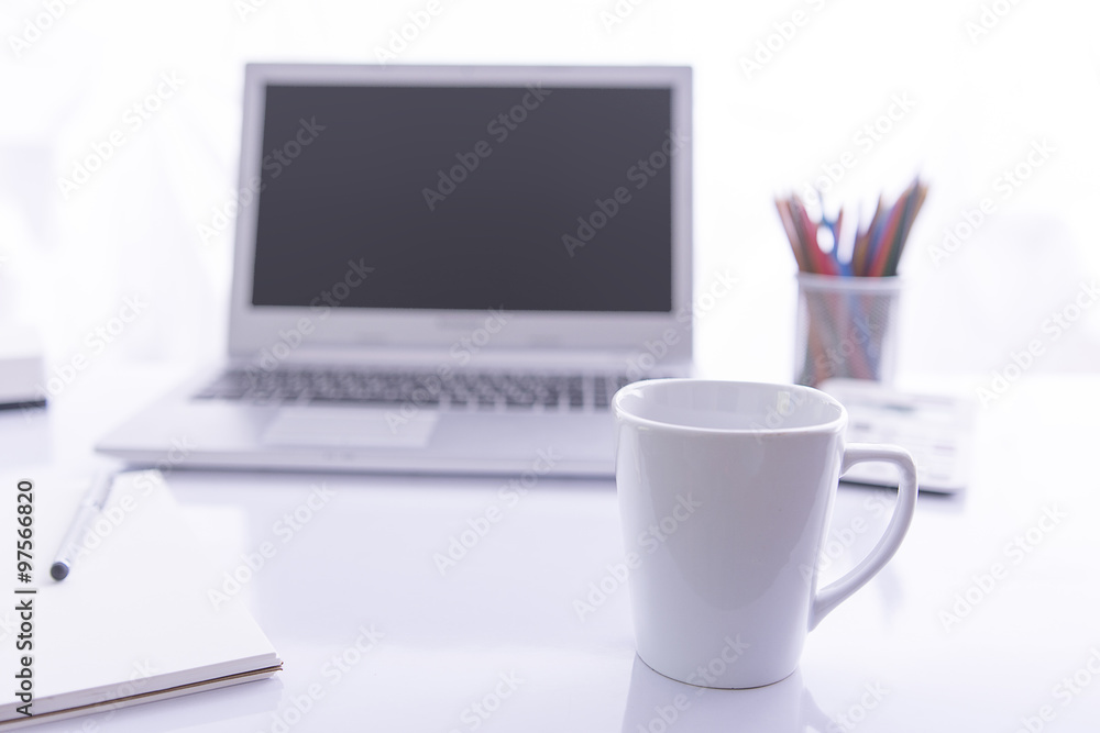 Office desk selective focus on white glass Office desk selective focus on white glass