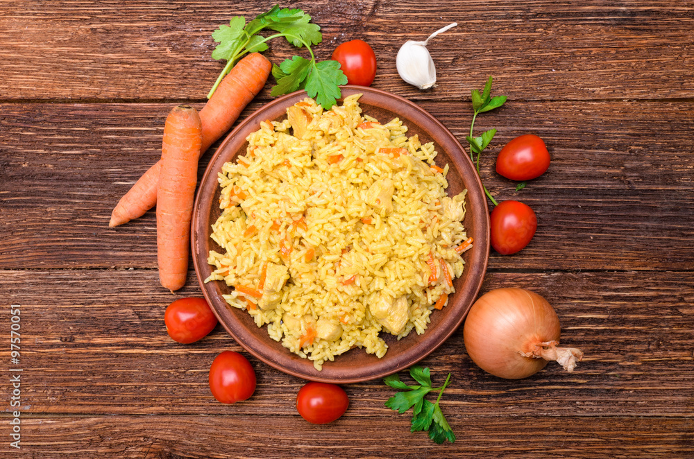 Pilaf on the plate on a wooden table. Pilaf on the plate on a wooden table.