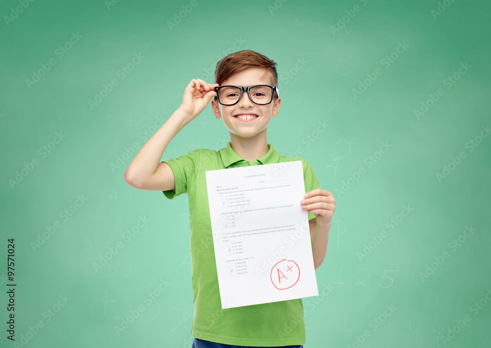 © Syda Productions - happy boy in eyeglasses holding school test result