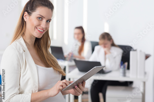 Businesswoman touching tablet's screen