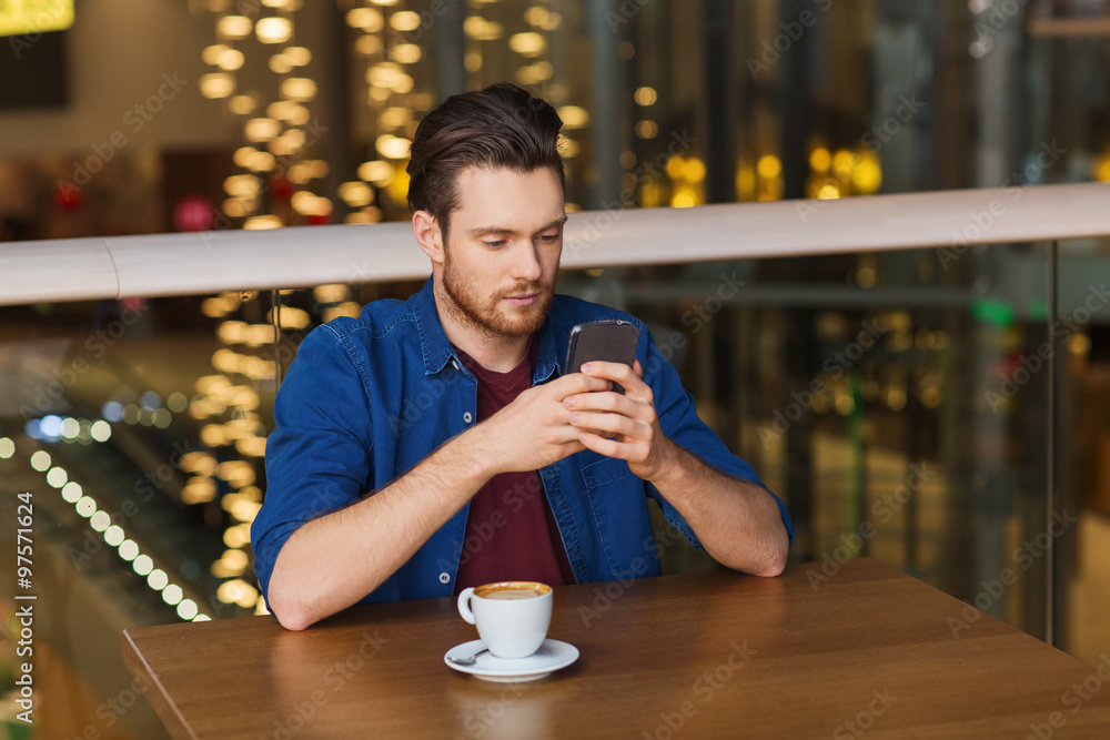 man with smartphone and coffee at restaurant