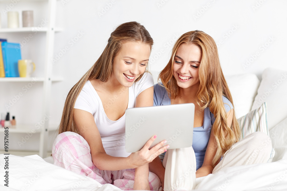 happy friends or teen girls with tablet pc at home happy friends or teen girls with tablet pc at home
