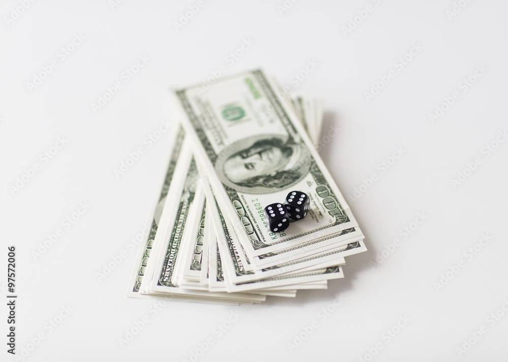 close up of black dice and dollar cash money close up of black dice and dollar cash money