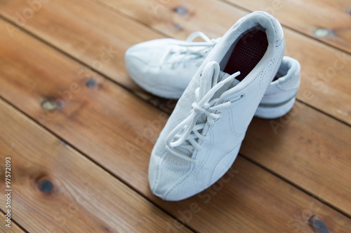 close up of sneakers on wooden floor