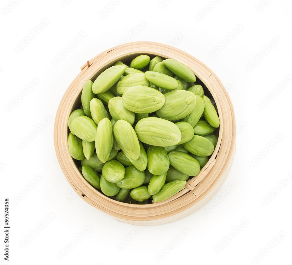 Parkia speciosa seeds or bitter bean in bamboo baskets on white Parkia speciosa seeds or bitter bean in bamboo baskets on white