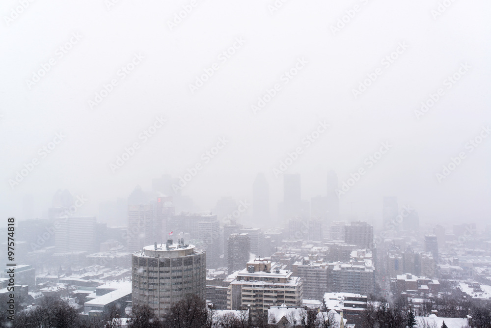 view of the downtown of montreal during a snow storm in a cold winter in canada