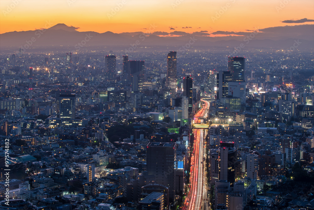 The sun sets over the cityscape of Tokyo