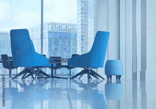 Small seat and modern blue office arm chairs in open space boardroom