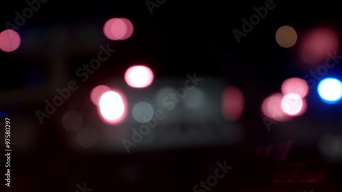 Ambulance, Cops and Firetrucks Blurry Lights Background at Night during a House Fire