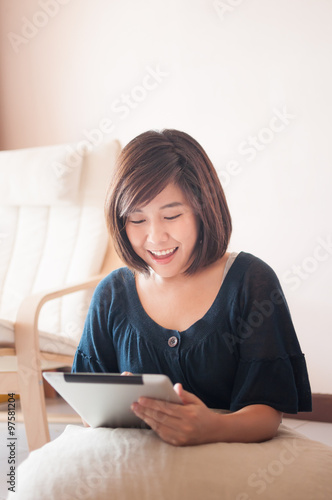 Young asian woman holding blank digital tablet.