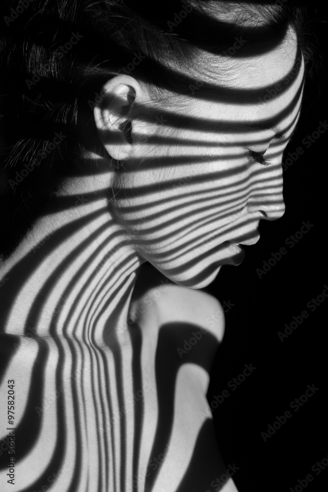 Naklejka premium The face of woman with black and white zebra stripes