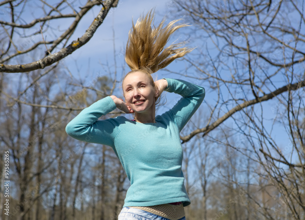 The woman jumps in the early spring wood The woman jumps in the early spring wood