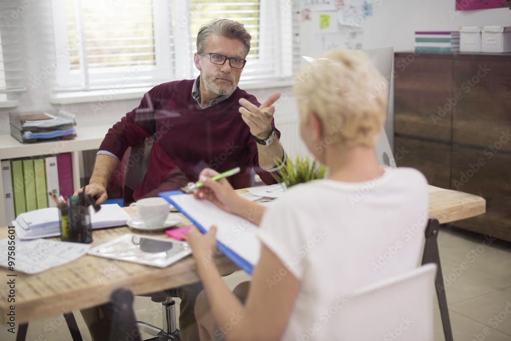 Business conversation behind the glass wall