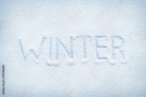 Text WINTER written on snow. Horizontal postcard.