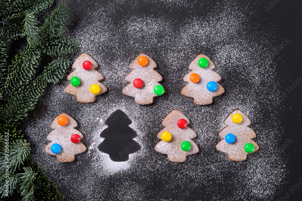 ginger cookies in powdered sugar with bright Christmas candy