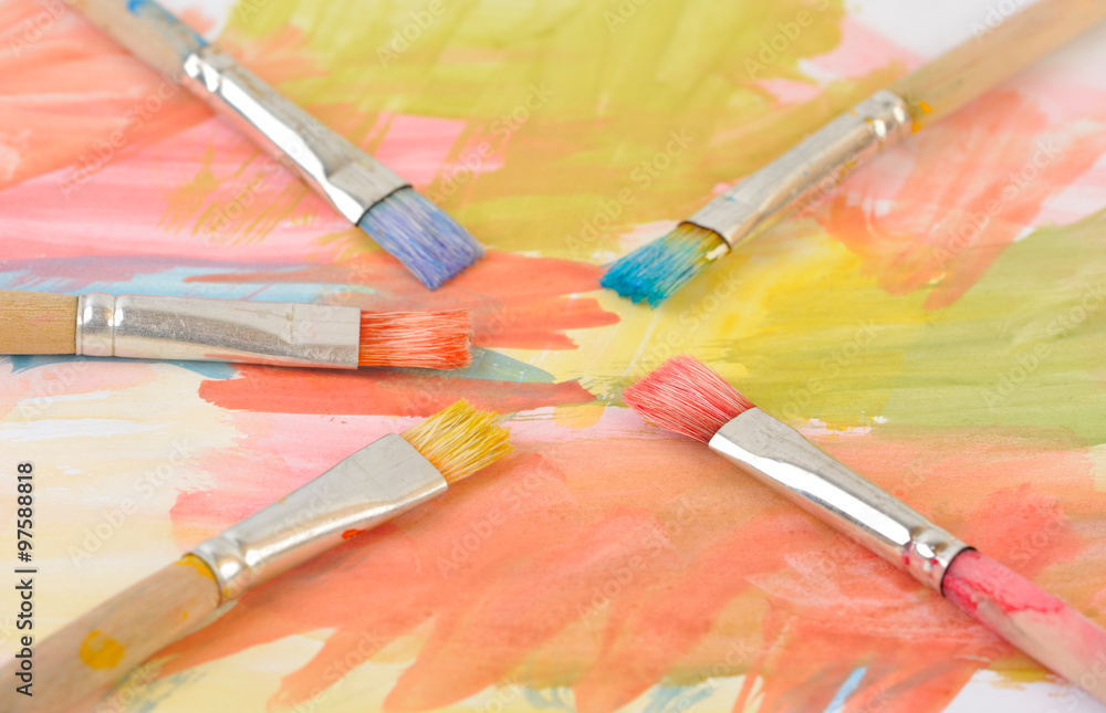 Fototapeta premium Paintbrushes on colorful painting