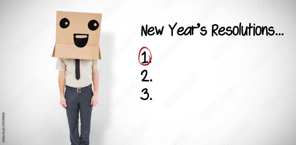Composite image of businessman standing with box on head 